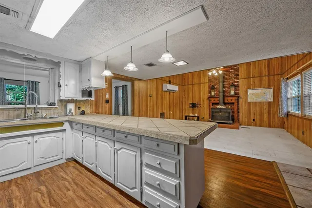 a bed sitting in a spacious bedroom next to a window