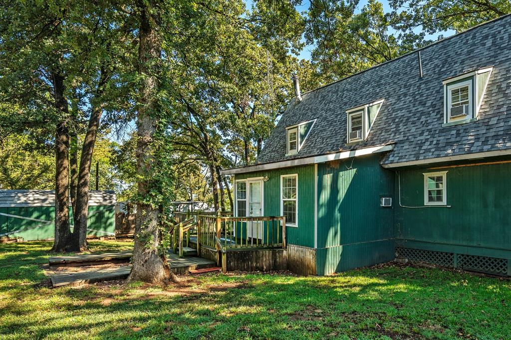241 Robin Hood Road Gordonville, TX 76245 - Photo 27 of 40 a view of a backyard with plants and large trees