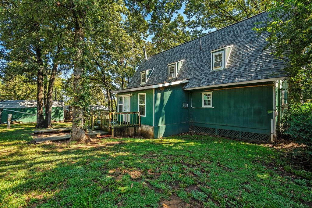 241 Robin Hood Road Gordonville, TX 76245 - Photo 28 of 40 a view of a brick house with a big yard and large trees