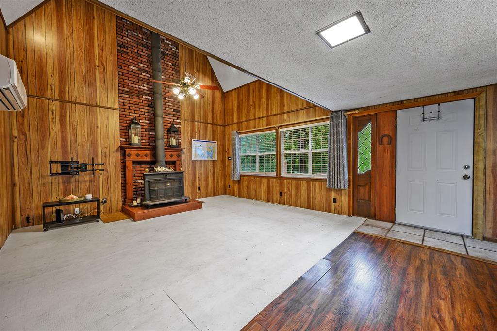 241 Robin Hood Road Gordonville, TX 76245 - Photo 3 of 40 an empty room with wooden floor and windows