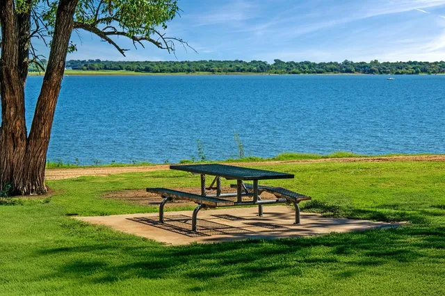 a spacious bathroom with a double vanity sink toilet and a mirror