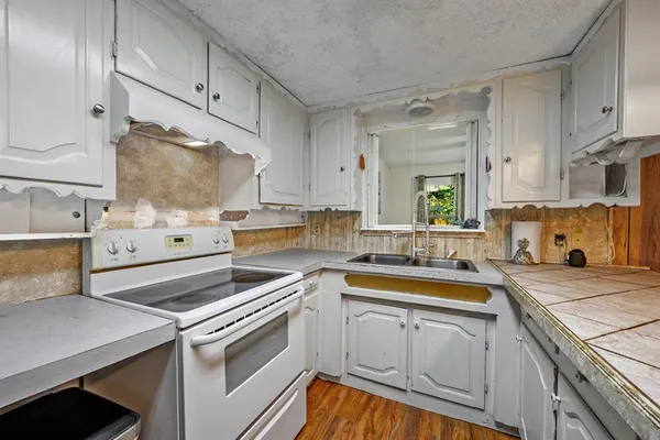 a spacious bathroom with a double vanity sink toilet and a mirror