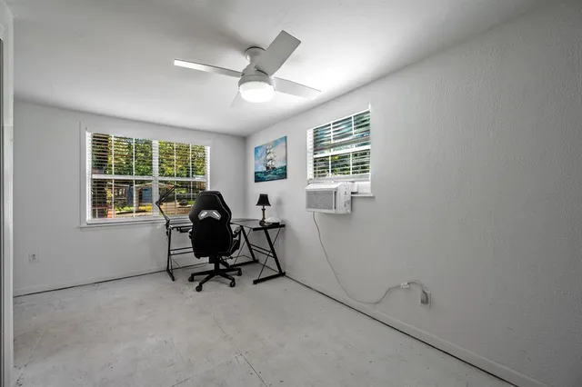 an empty room with windows and closet