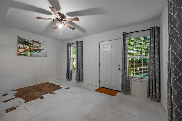 a view of a livingroom with a ceiling fan and window