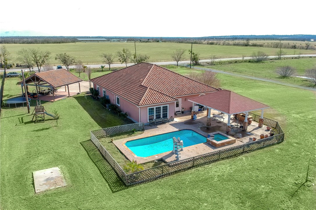 12320 Ballerstedt Road Elgin, TX 78621 - Photo 1 of 1 an aerial view of a house with a garden and lake view
