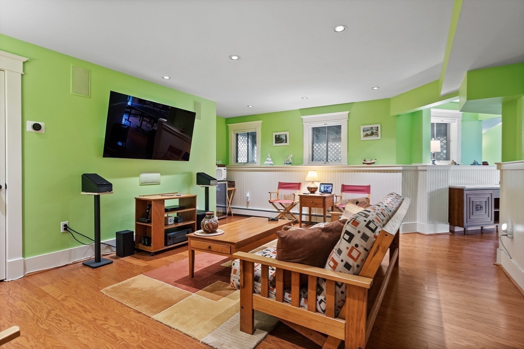 5 Walnut Street Lexington, MA 02421 - Photo 21 of 34 a living room with furniture a flat screen tv and a fireplace
