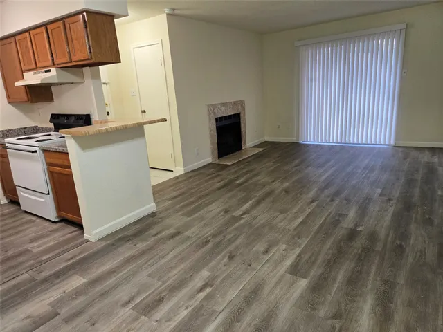 a view of a kitchen with wooden floor and a sink