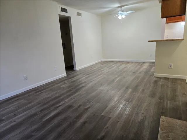 an empty room with wooden floor and closet