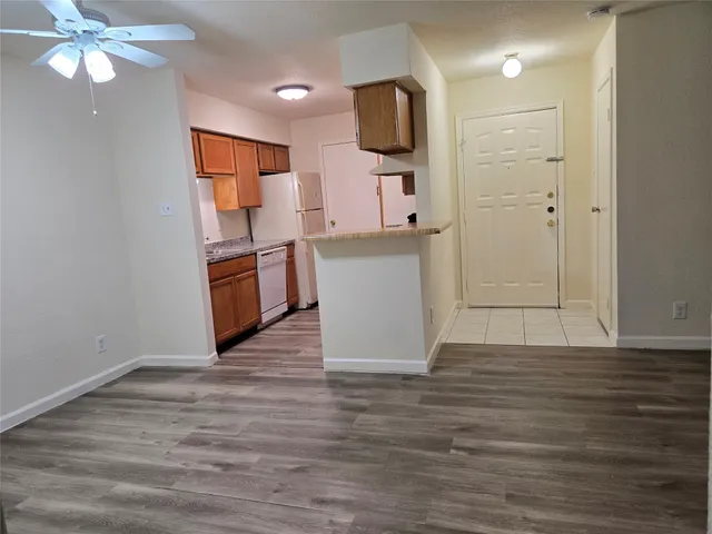 a view of kitchen with wooden floor electronic appliances and window