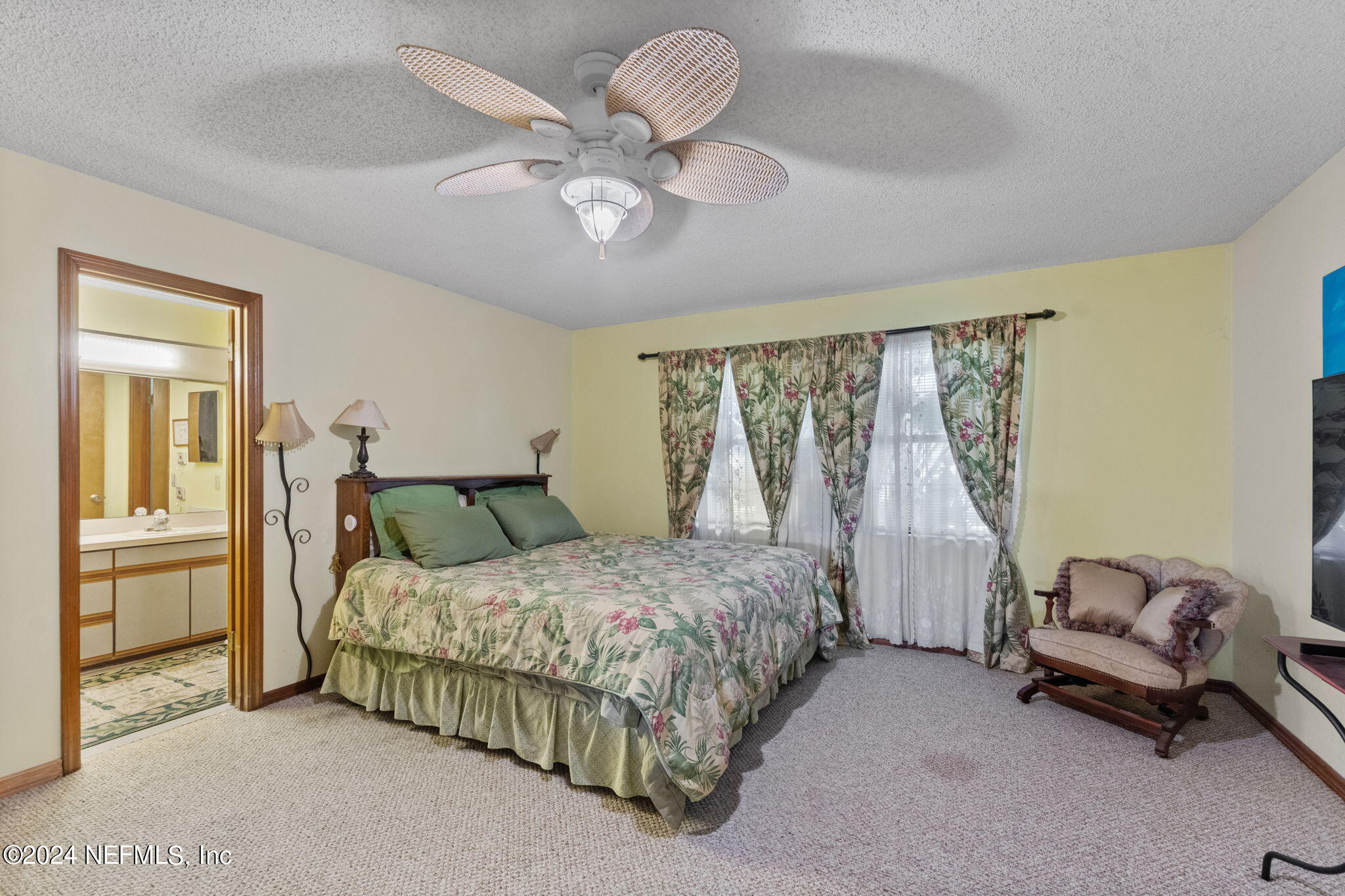 312 Linden Road St. Augustine, FL 32086 - Photo 14 of 40 a bedroom with a bed and chandelier