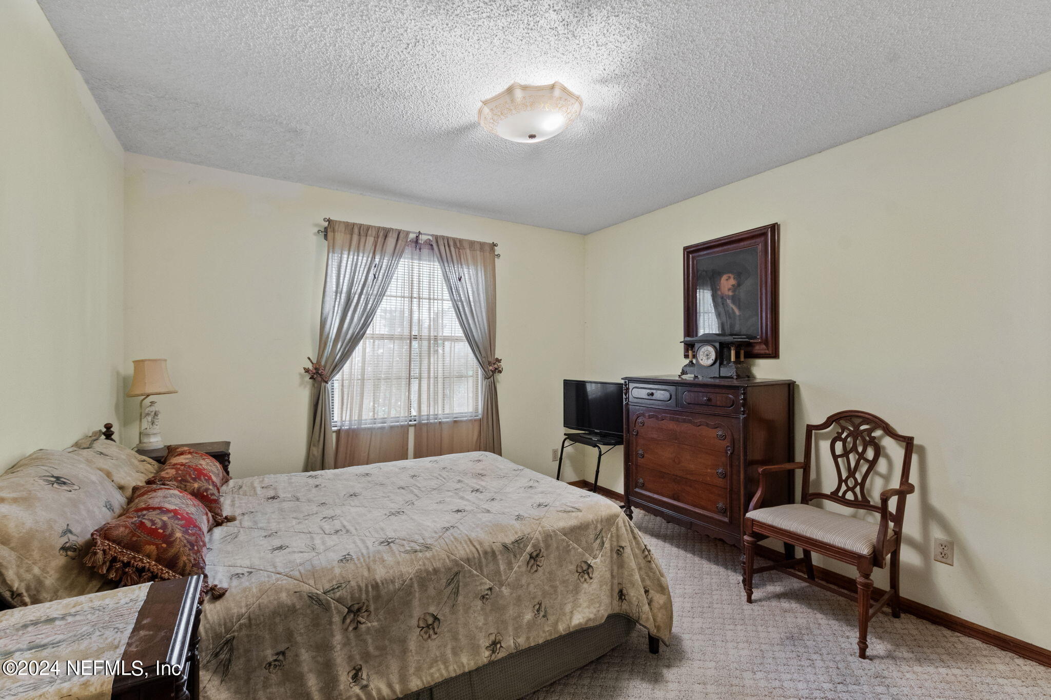 312 Linden Road St. Augustine, FL 32086 - Photo 16 of 40 a bedroom with a bed and a chandelier