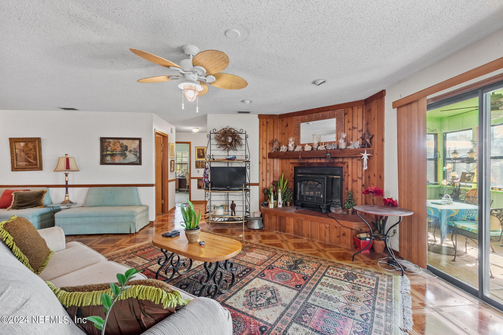 312 Linden Road St. Augustine, FL 32086 - Photo 9 of 40 a living room with furniture a fireplace and a large window