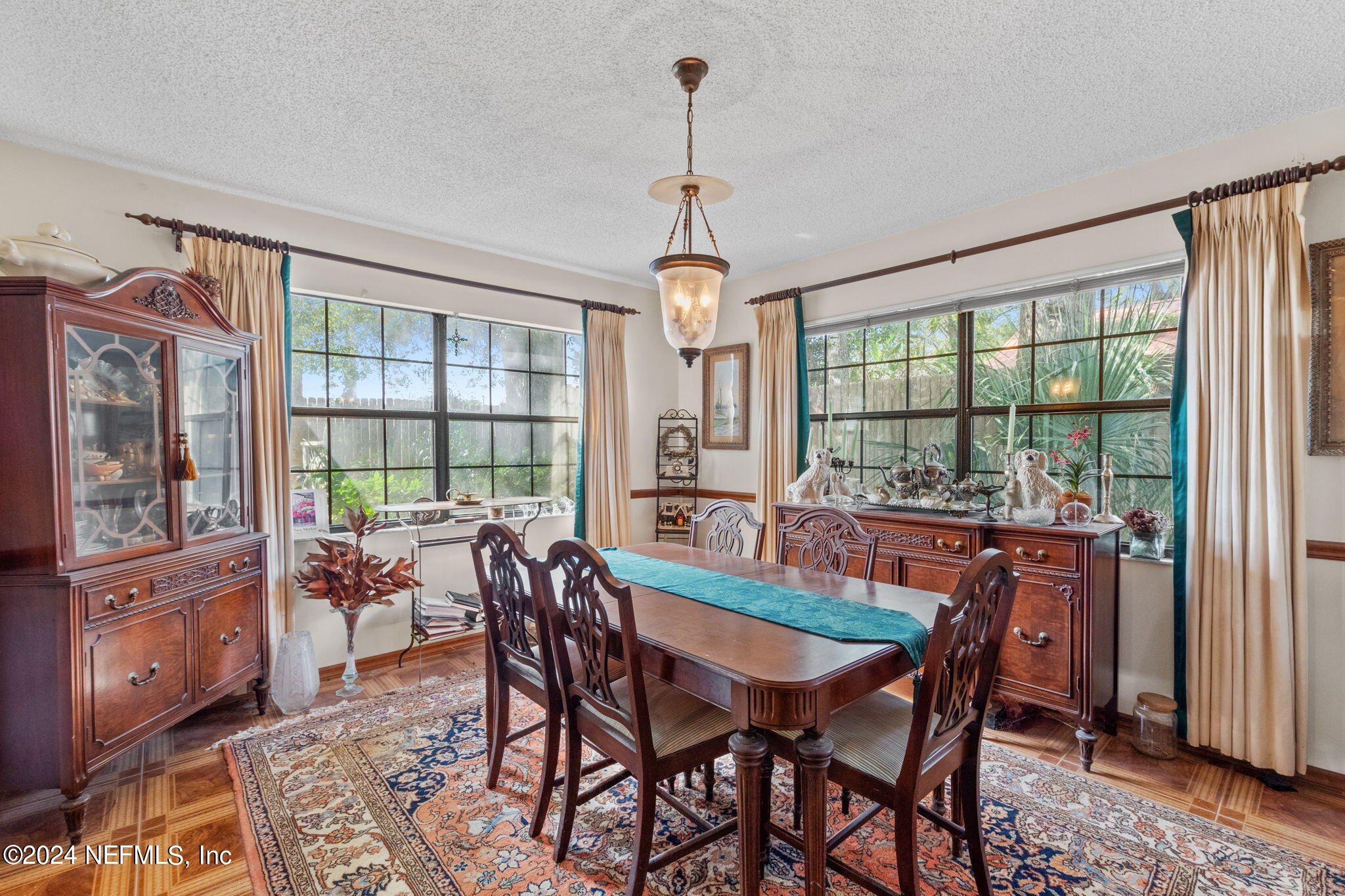 312 Linden Road St. Augustine, FL 32086 - Photo 10 of 40 a dining room with furniture a chandelier and wooden floor