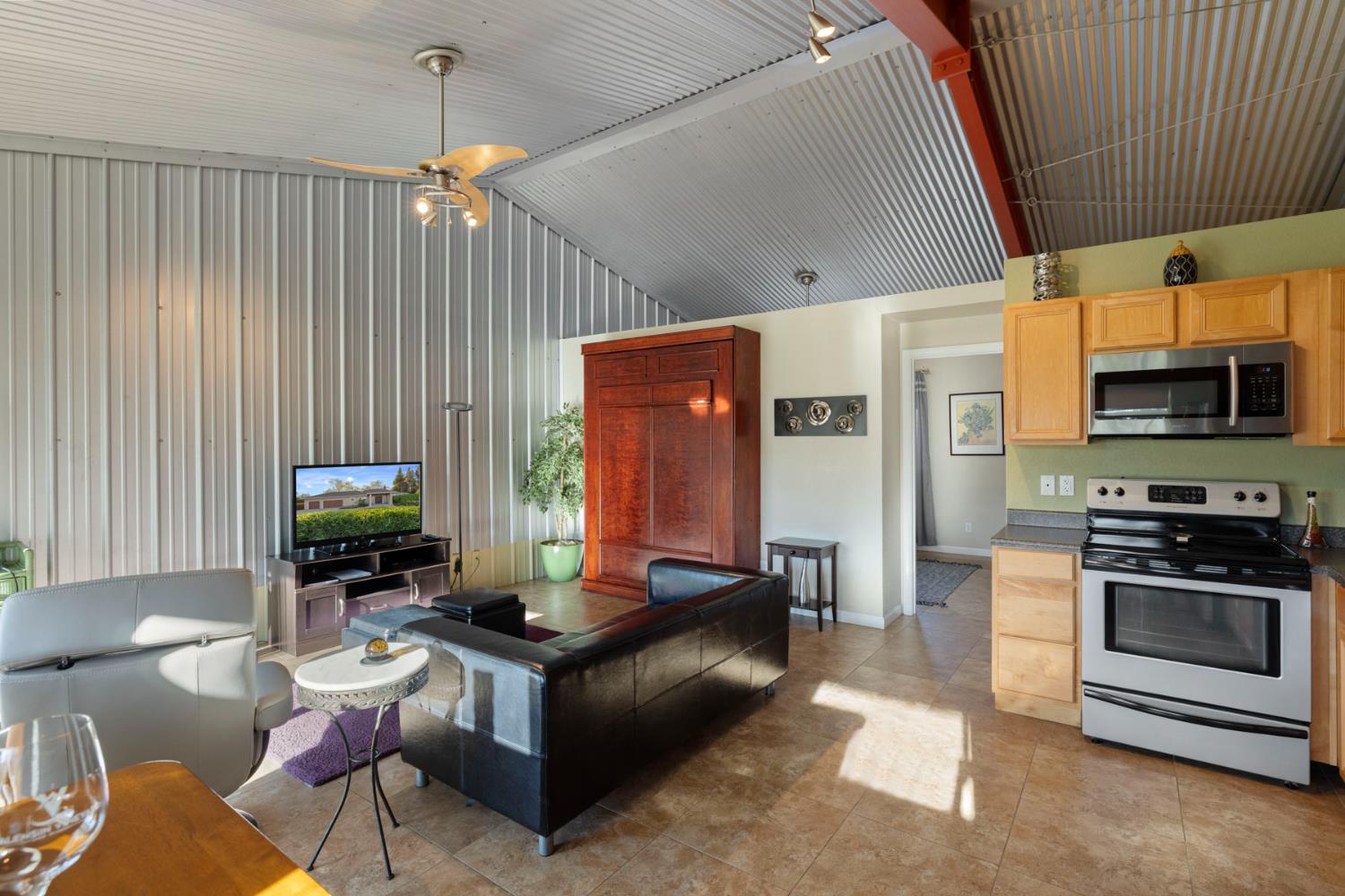 10675 Valensin Road Galt, CA 95632 - Photo 13 of 99 a living room with fireplace furniture and a flat screen tv