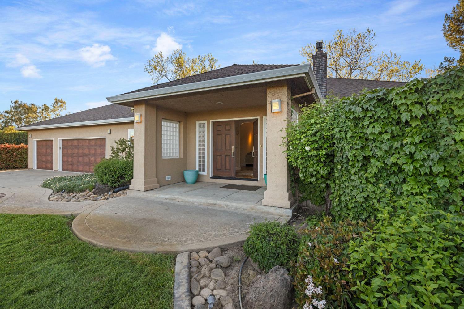 10675 Valensin Road Galt, CA 95632 - Photo 22 of 99 front view of a house with a garden
