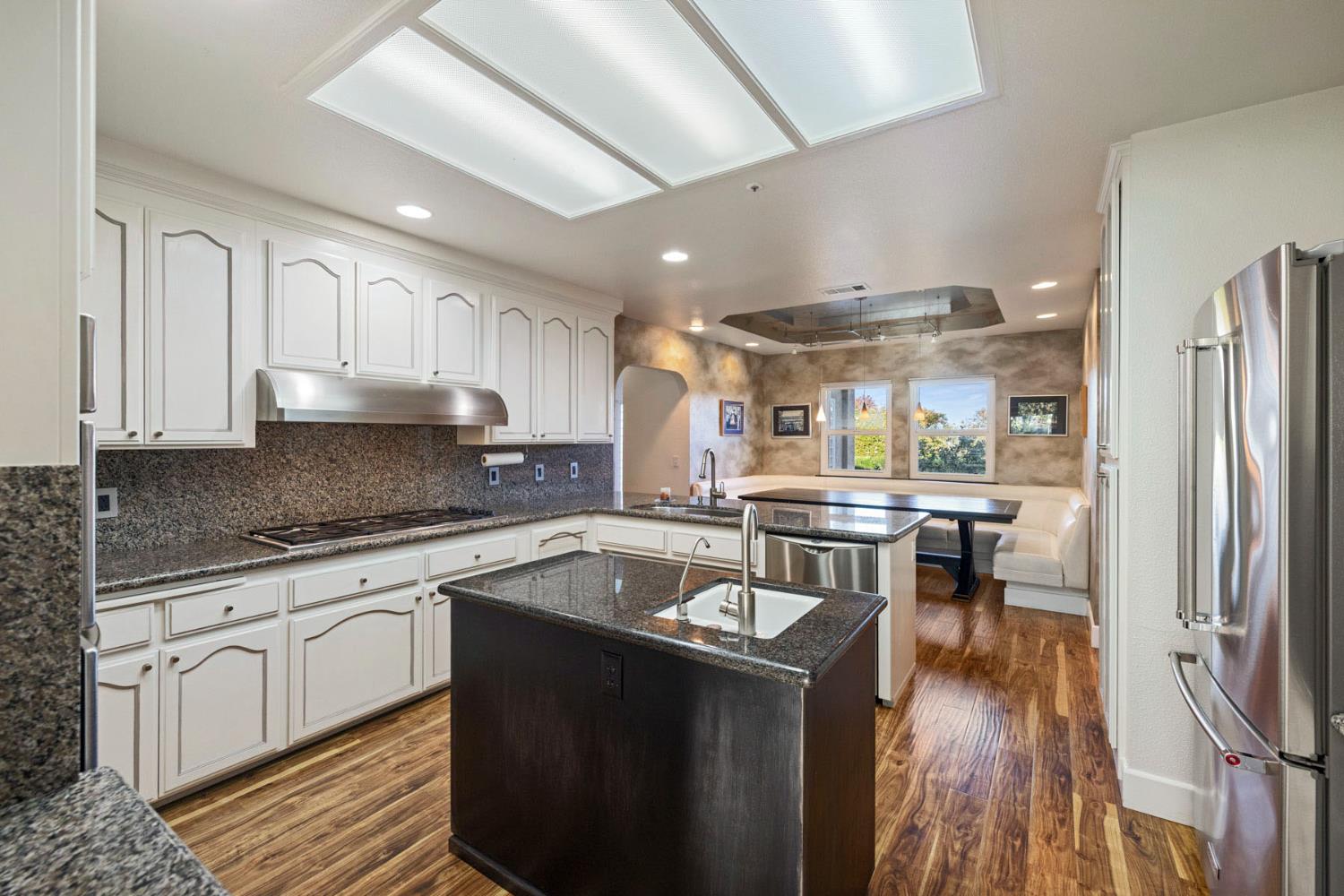 10675 Valensin Road Galt, CA 95632 - Photo 29 of 99 a kitchen with stainless steel appliances granite countertop a sink stove and refrigerator