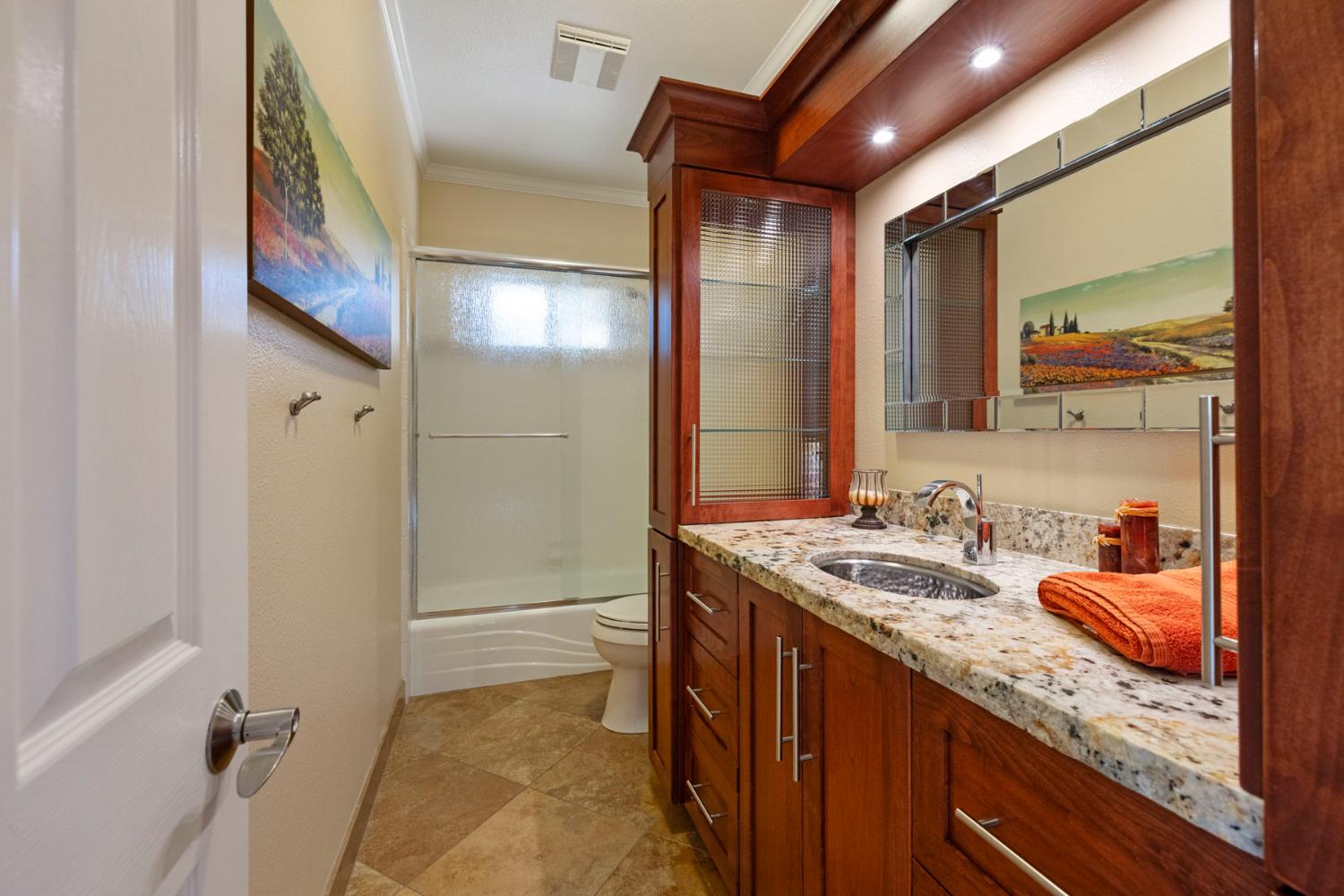 10675 Valensin Road Galt, CA 95632 - Photo 50 of 99 a bathroom with a granite countertop sink and a mirror