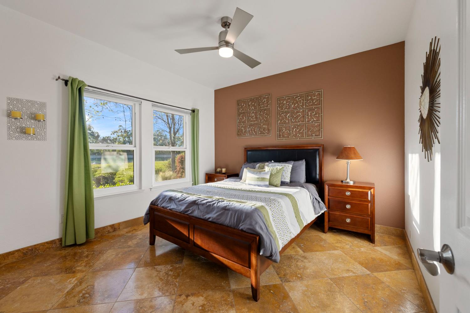 10675 Valensin Road Galt, CA 95632 - Photo 51 of 99 a bedroom with a large bed and a chandelier