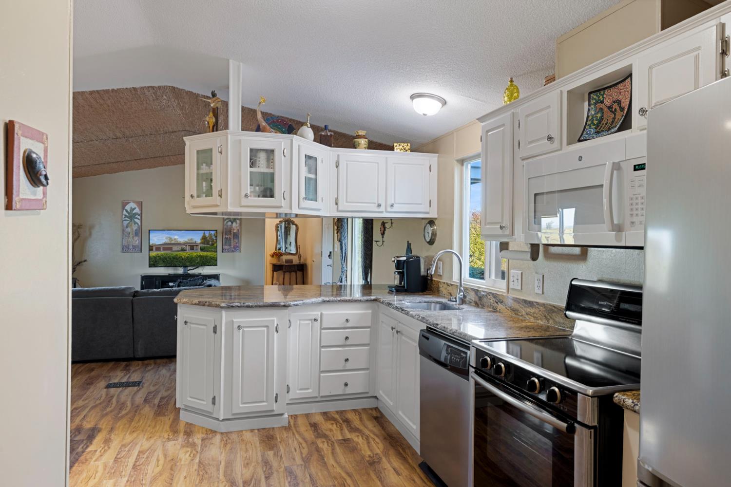 10675 Valensin Road Galt, CA 95632 - Photo 60 of 99 a kitchen with stainless steel appliances granite countertop a stove and a sink