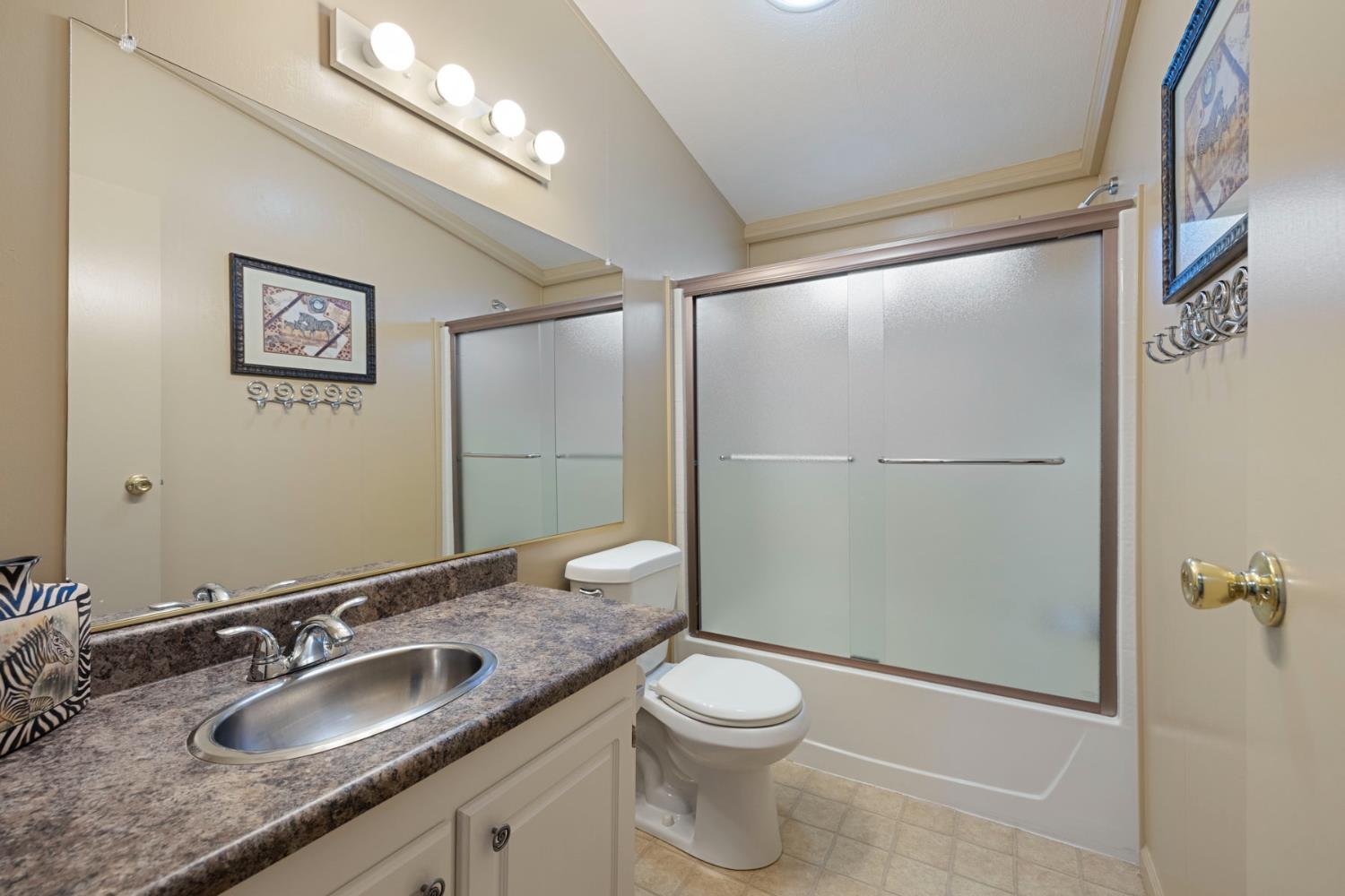 10675 Valensin Road Galt, CA 95632 - Photo 71 of 99 a bathroom with a granite countertop sink toilet and shower