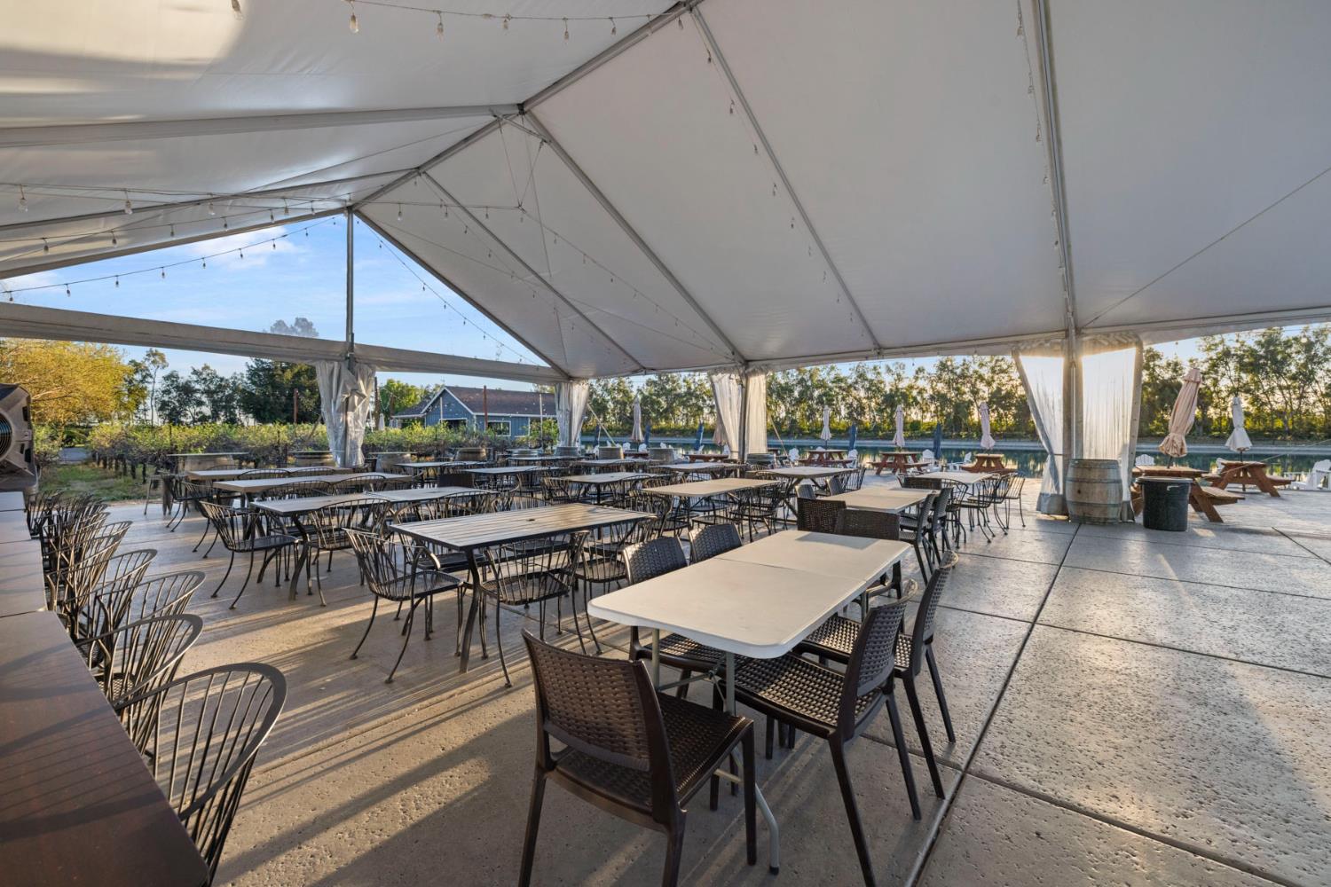 10675 Valensin Road Galt, CA 95632 - Photo 91 of 99 a view of a patio with table and chairs under an umbrella