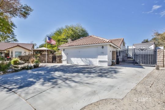 1220 Jennifer Court Ridgecrest, CA 93555 - Photo 34 of 34 a front view of a house with a yard and garage