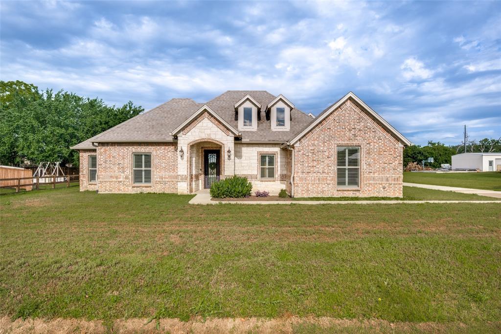 444 Ben Boyd Road Argyle, TX 76226 - Photo 2 of 28 a front view of a house with a garden