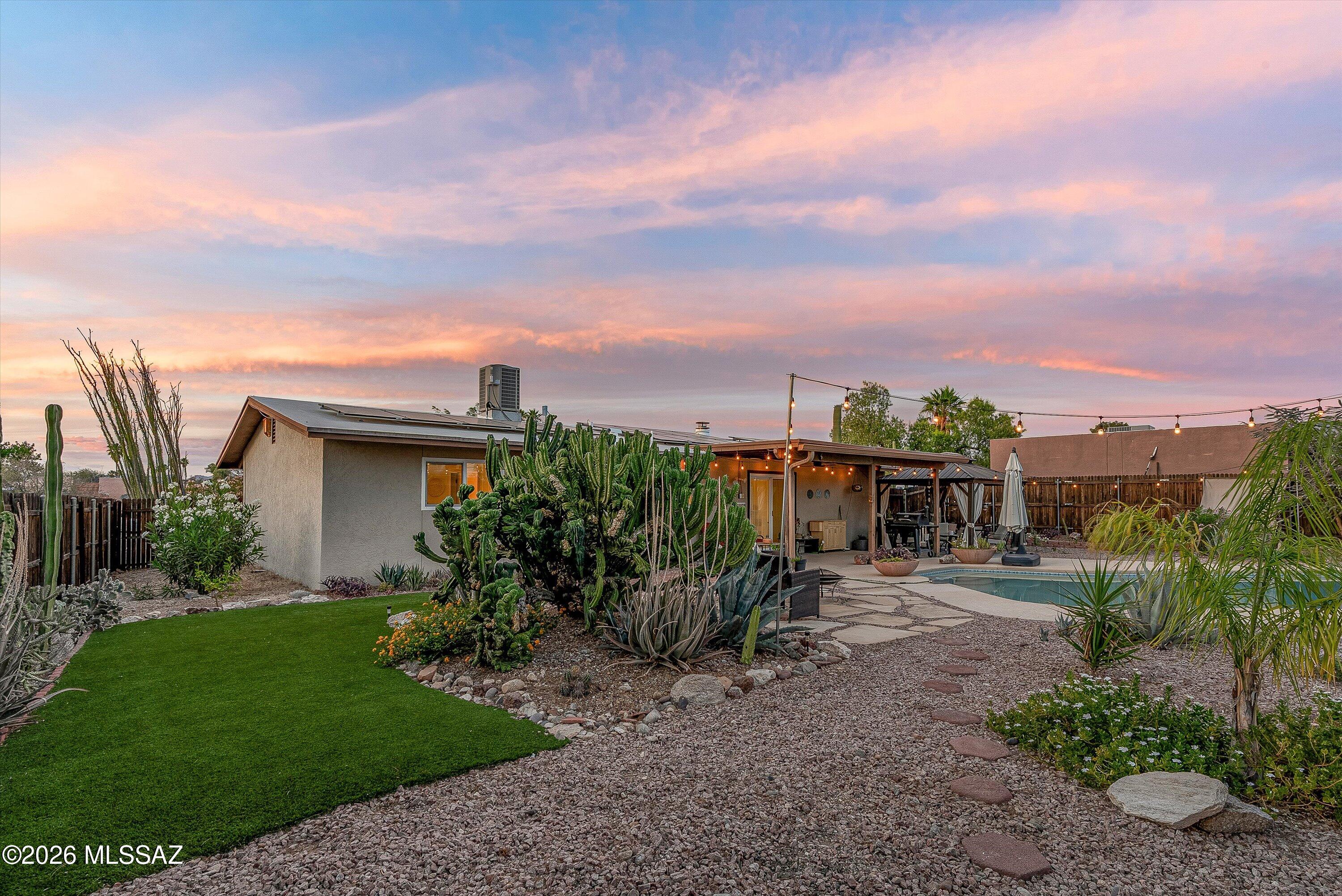 3949 West Mars Street Tucson, AZ 85741 - Photo 3 of 27 a view of a yard with plants and a bench