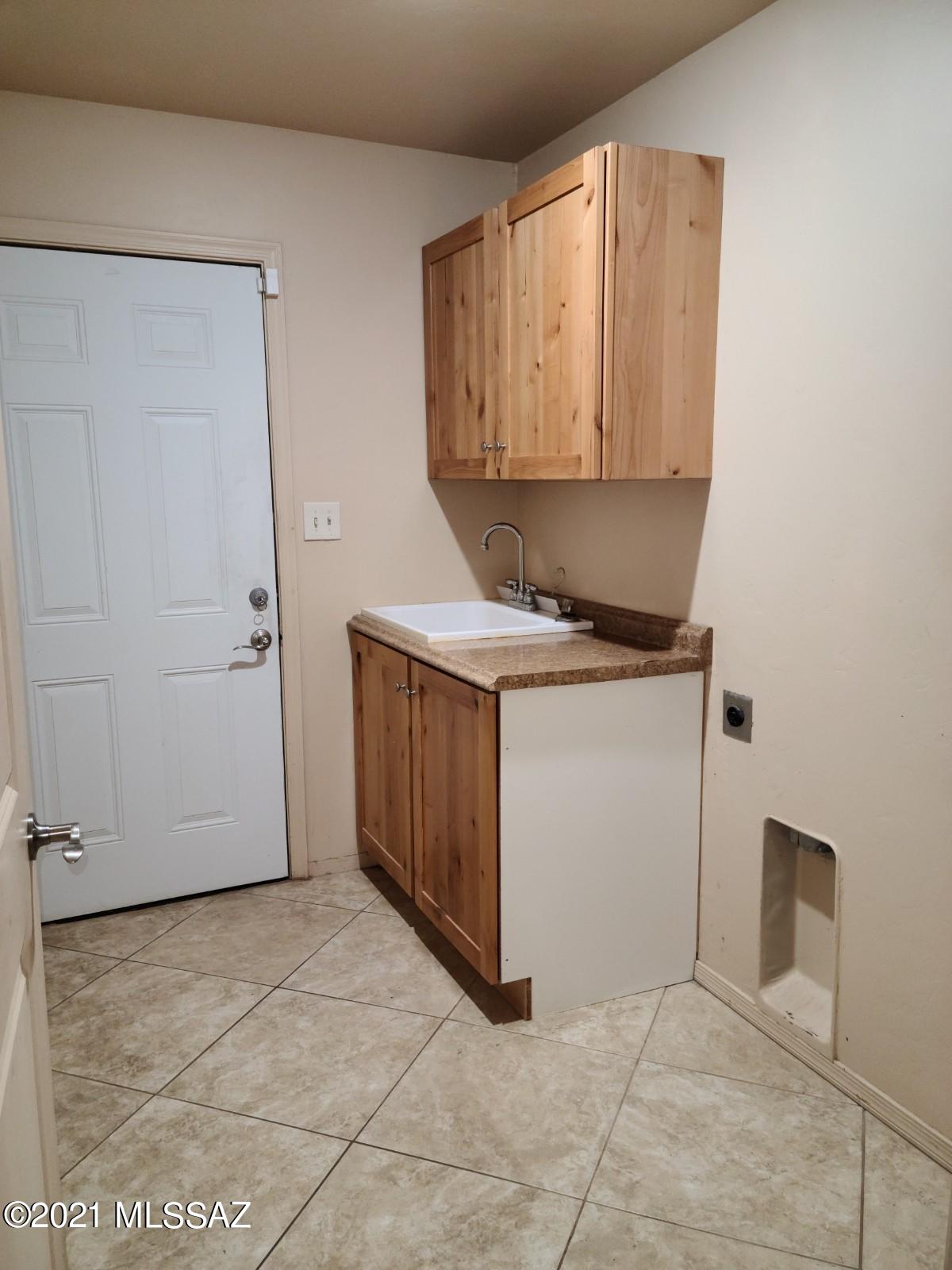 1038 Oso Court Rio Rico, AZ 85648 - Photo 37 of 50 a view of a kitchen with white cabinets