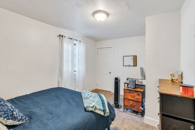 358 400 South Provo, UT 84601 - Photo 24 of 34 Bedroom with light carpet, a desk, and a textured ceiling.