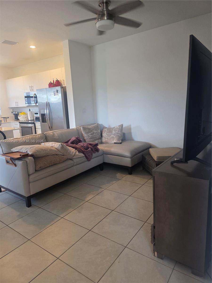 23231 Southwest 129th Path Homestead, FL 33032 - Photo 23 of 33 a living room with furniture and a flat screen tv