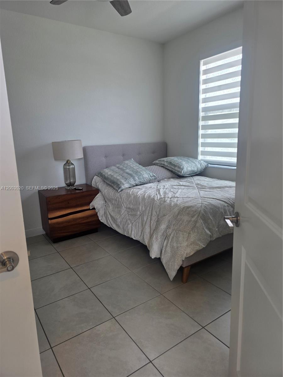 23231 Southwest 129th Path Homestead, FL 33032 - Photo 24 of 33 a bedroom with a bed and a window