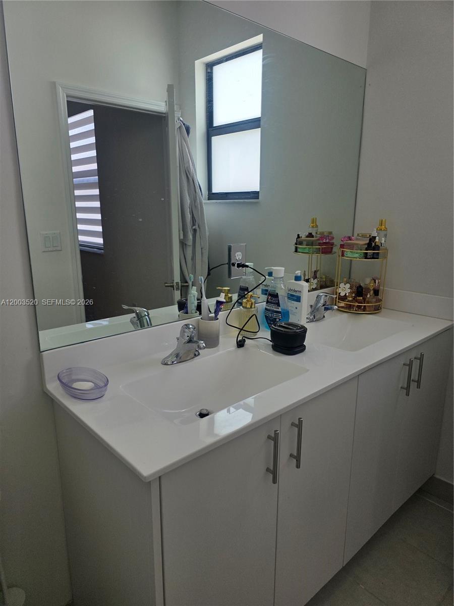 23231 Southwest 129th Path Homestead, FL 33032 - Photo 26 of 33 a bathroom with a sink vanity and mirror