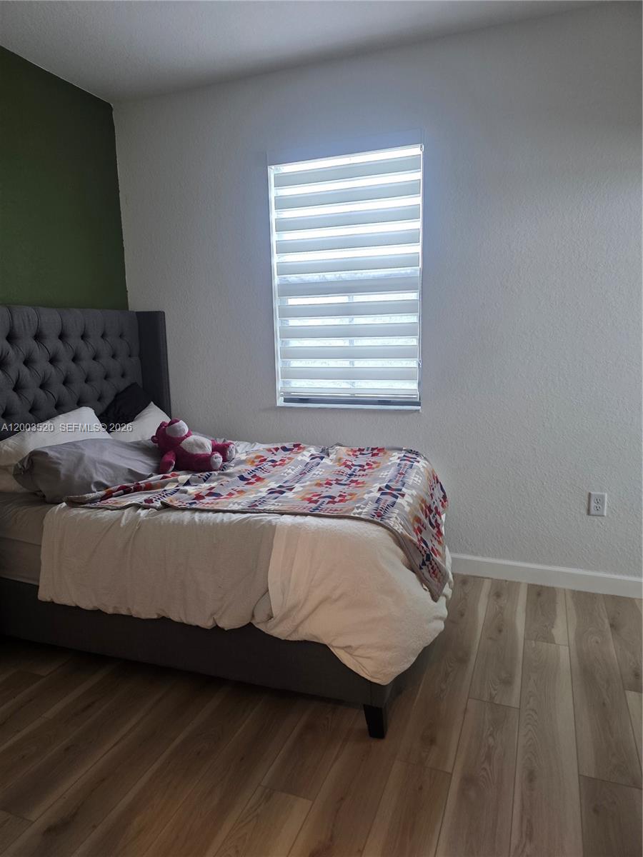 23231 Southwest 129th Path Homestead, FL 33032 - Photo 27 of 33 a bed sitting in a bedroom next to a window