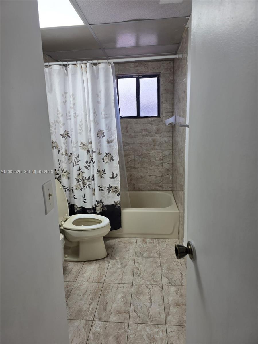 23231 Southwest 129th Path Homestead, FL 33032 - Photo 29 of 33 a white toilet sitting next to a bathtub