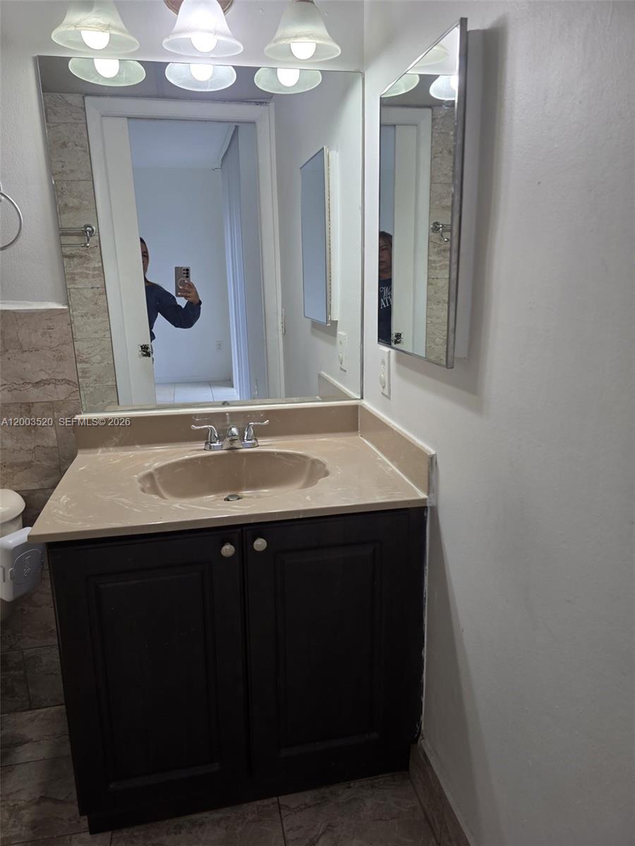 23231 Southwest 129th Path Homestead, FL 33032 - Photo 32 of 33 a bathroom with a sink and a mirror