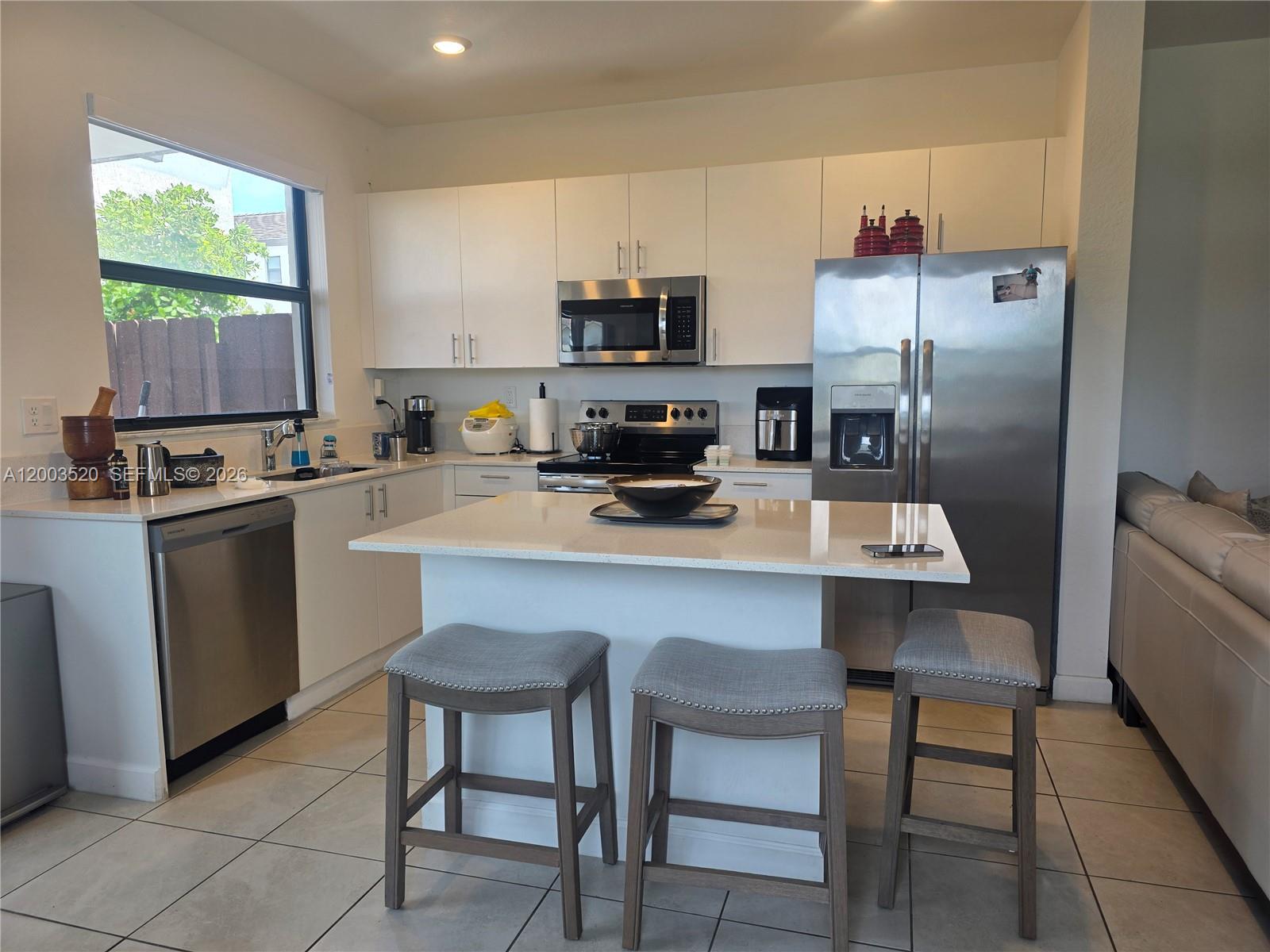 23231 Southwest 129th Path Homestead, FL 33032 - Photo 4 of 33 a kitchen with a sink cabinets and window