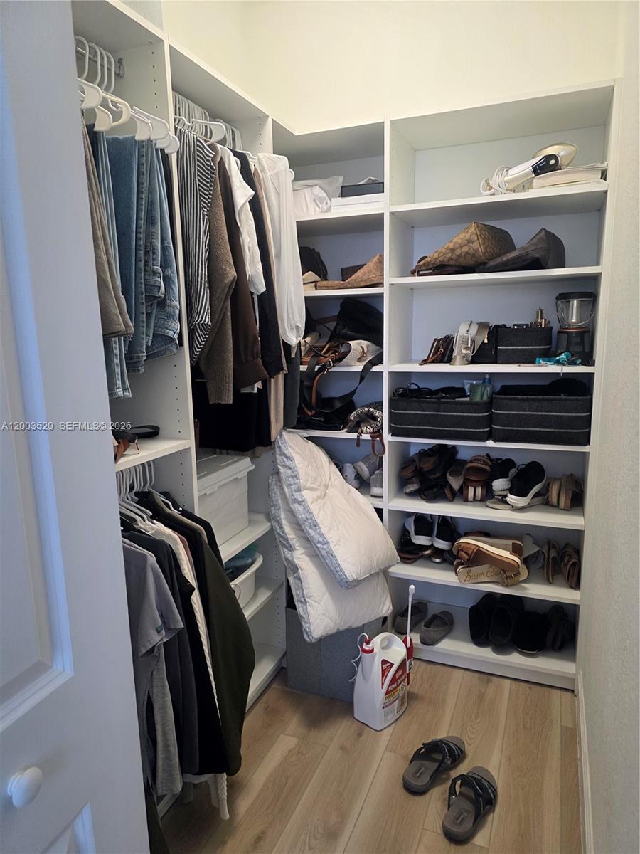 23231 Southwest 129th Path Homestead, FL 33032 - Photo 10 of 33 a view of walk in closet with clothes and shoes