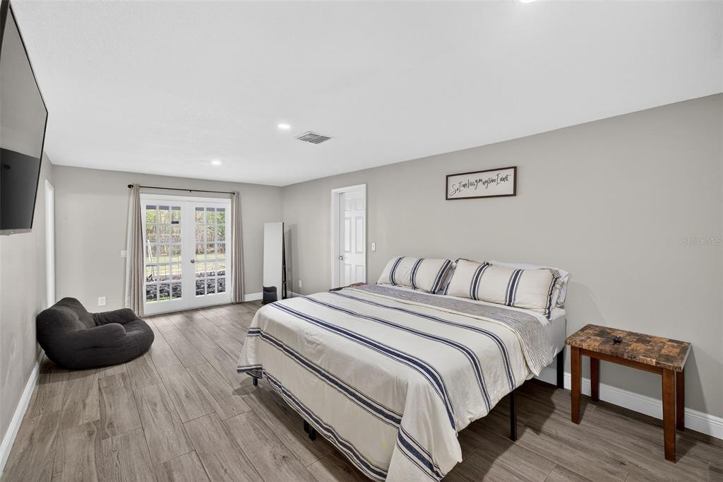182 Parsons Road Longwood, FL 32779 - Photo 11 of 54 a spacious bedroom with a bed and a couch