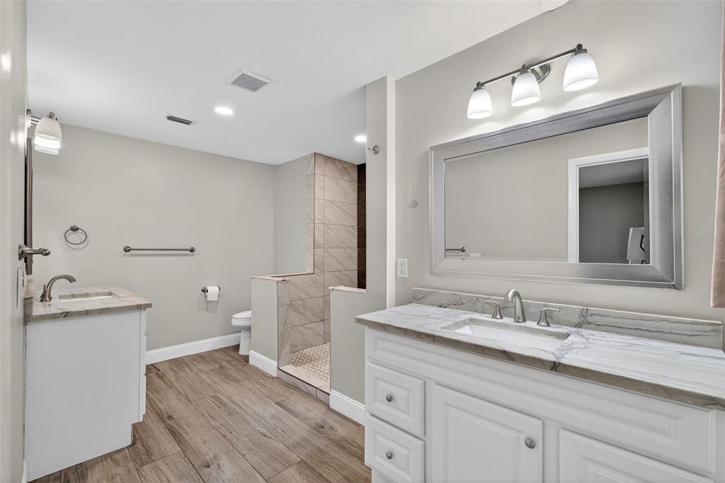 182 Parsons Road Longwood, FL 32779 - Photo 13 of 54 a spacious bathroom with a granite countertop sink a toilet and a mirror