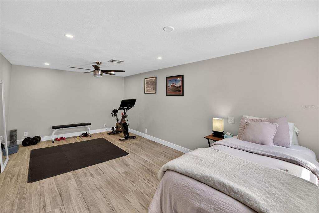 182 Parsons Road Longwood, FL 32779 - Photo 14 of 54 a bedroom with a bed and a lamp