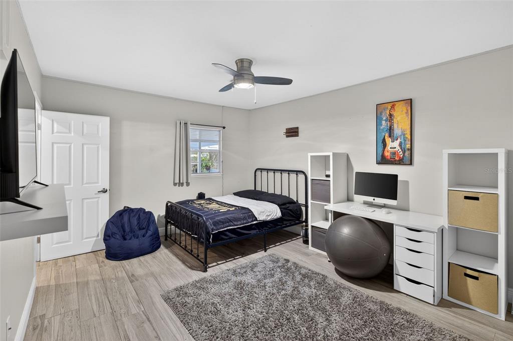 182 Parsons Road Longwood, FL 32779 - Photo 19 of 54 a bedroom with furniture and a flat screen tv