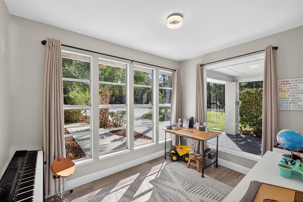 182 Parsons Road Longwood, FL 32779 - Photo 22 of 54 a work room with furniture and floor to ceiling windows