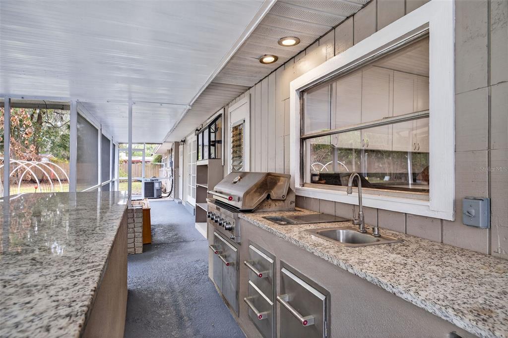 182 Parsons Road Longwood, FL 32779 - Photo 25 of 54 a kitchen with sink stove and cabinets
