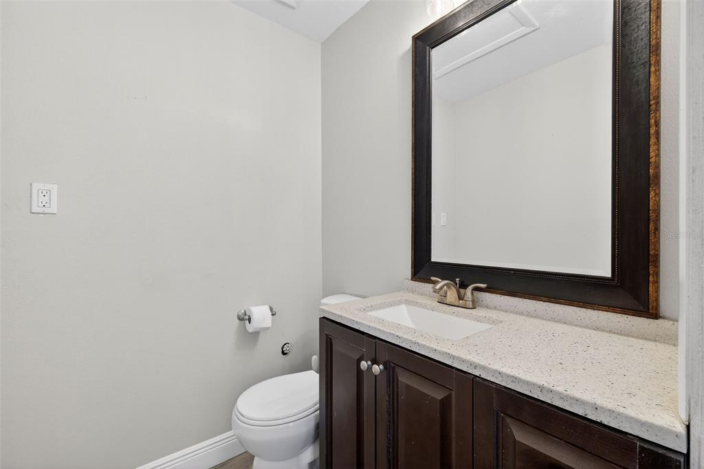 182 Parsons Road Longwood, FL 32779 - Photo 28 of 54 a bathroom with a granite countertop sink a toilet and a mirror