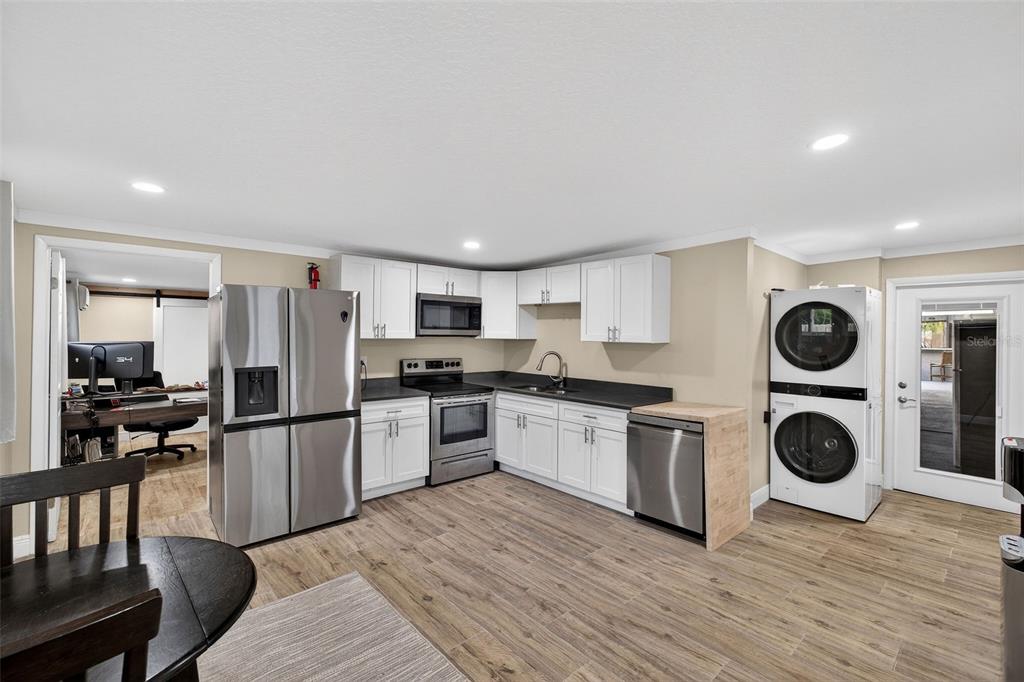 182 Parsons Road Longwood, FL 32779 - Photo 31 of 54 a kitchen with stainless steel appliances granite countertop a refrigerator a stove top oven a sink and dishwasher