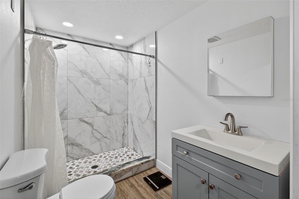 182 Parsons Road Longwood, FL 32779 - Photo 34 of 54 a bathroom with a sink toilet a mirror and shower