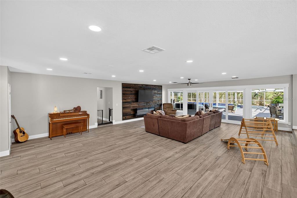 182 Parsons Road Longwood, FL 32779 - Photo 40 of 54 a living room with furniture and a wooden floor