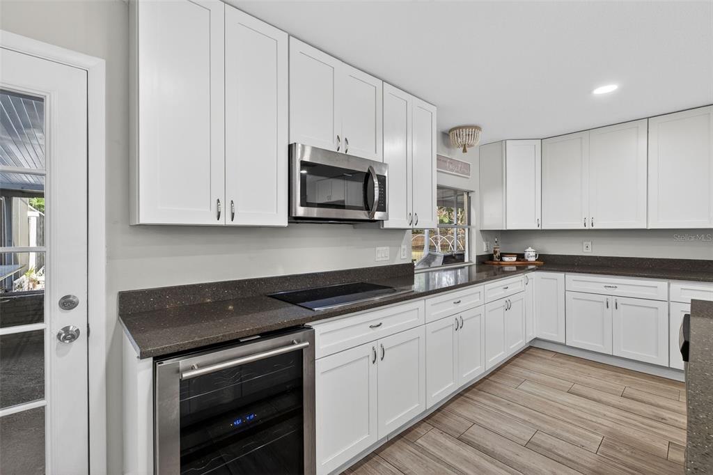 182 Parsons Road Longwood, FL 32779 - Photo 44 of 54 a kitchen with granite countertop white cabinets stainless steel appliances and a sink