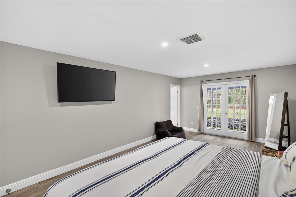 182 Parsons Road Longwood, FL 32779 - Photo 48 of 54 a bedroom with a bed and a flat screen tv